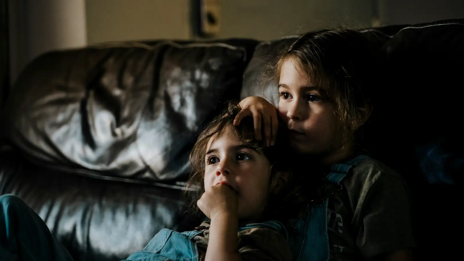 Family watching a film together at night